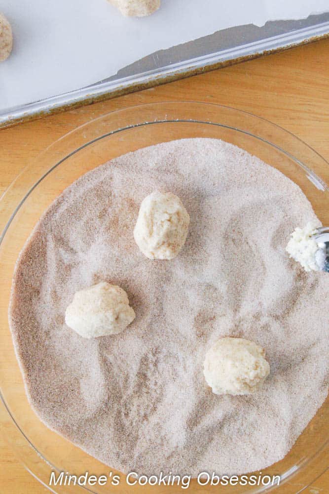 rolling dough in cinnamon sugar