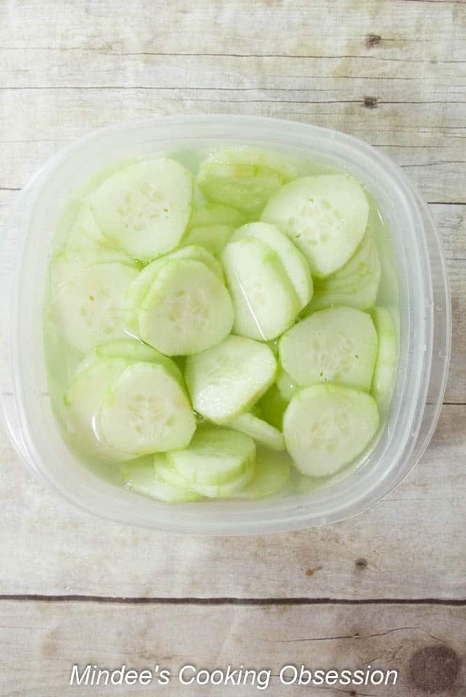 Sliced up cucumbers in the salt water.