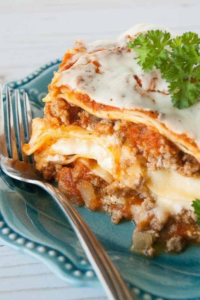 Square of lasagna on a plate.