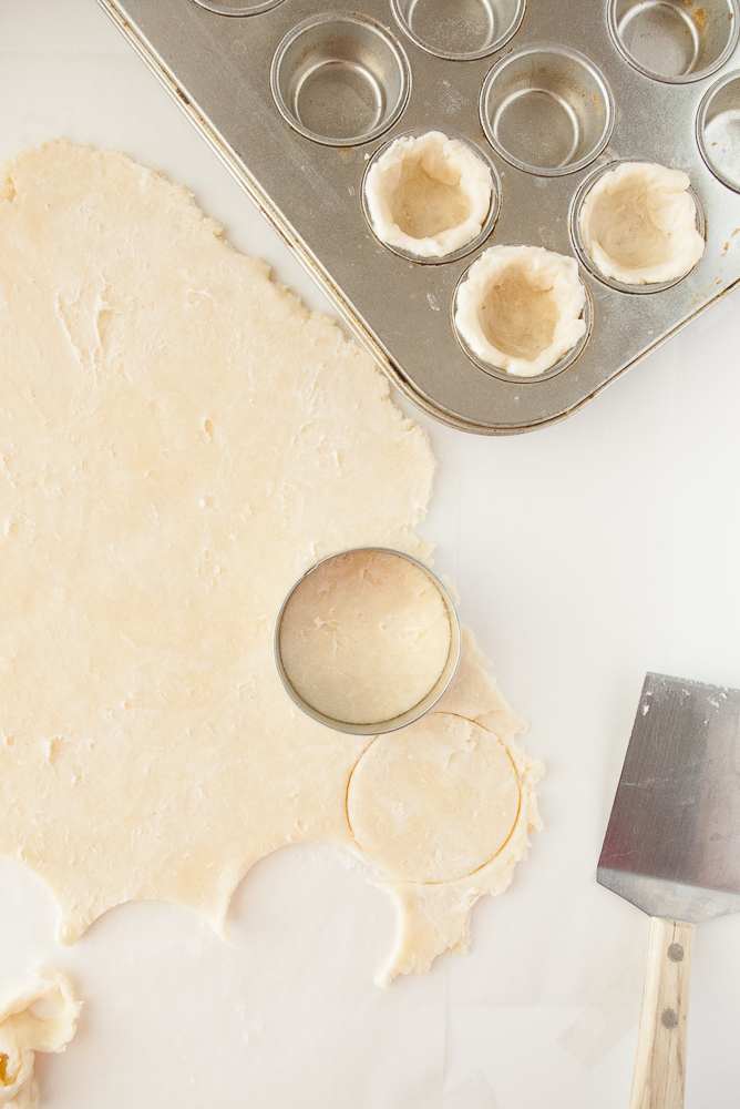 Pie dough being cut into little circles.