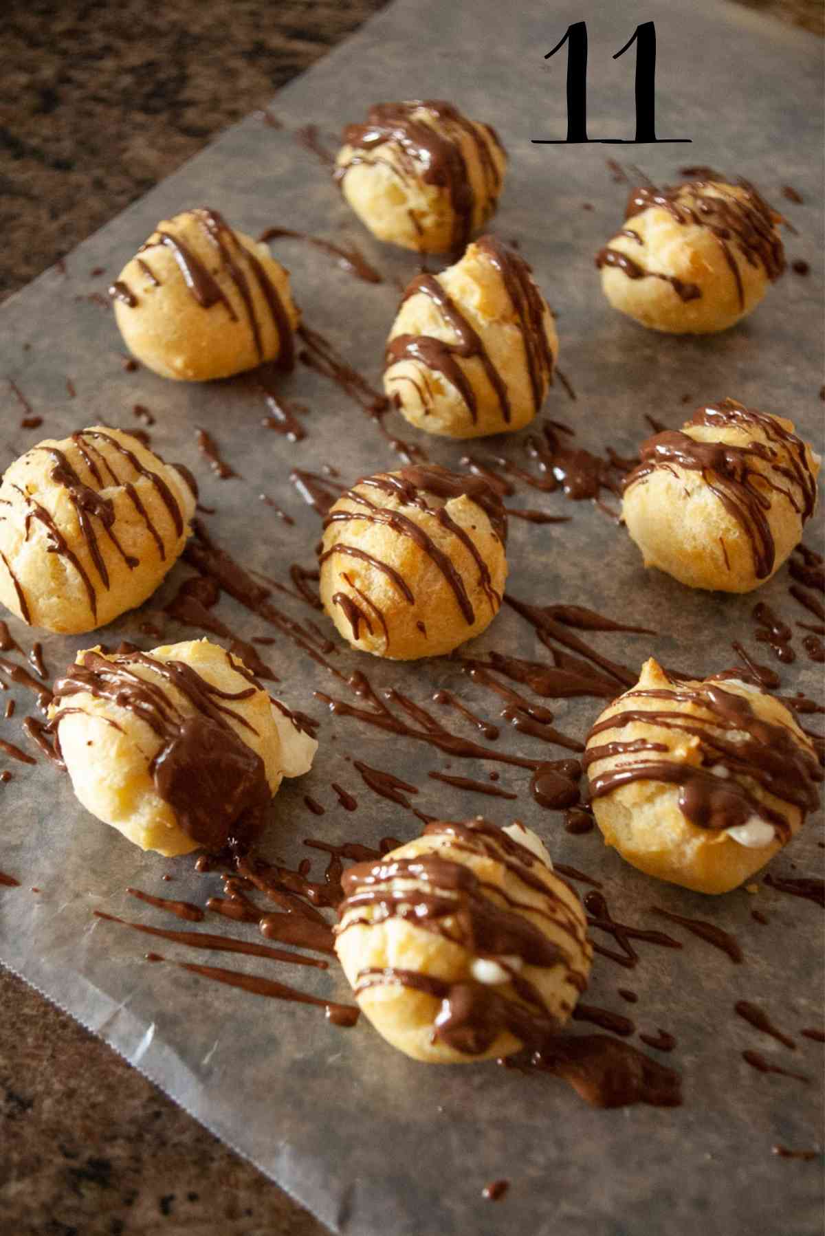Warm chocolate drizzled over the freshly filled cream puffs.