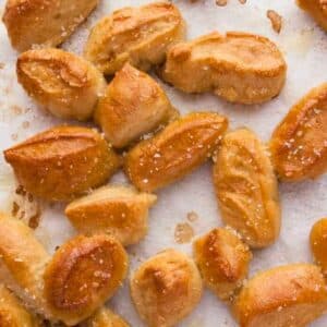 Soft pretzel bites on a baking tray.