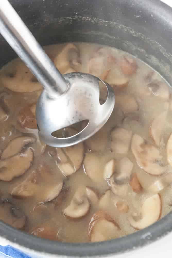 Simmered mushrooms about to be blended up with an immersion blender.