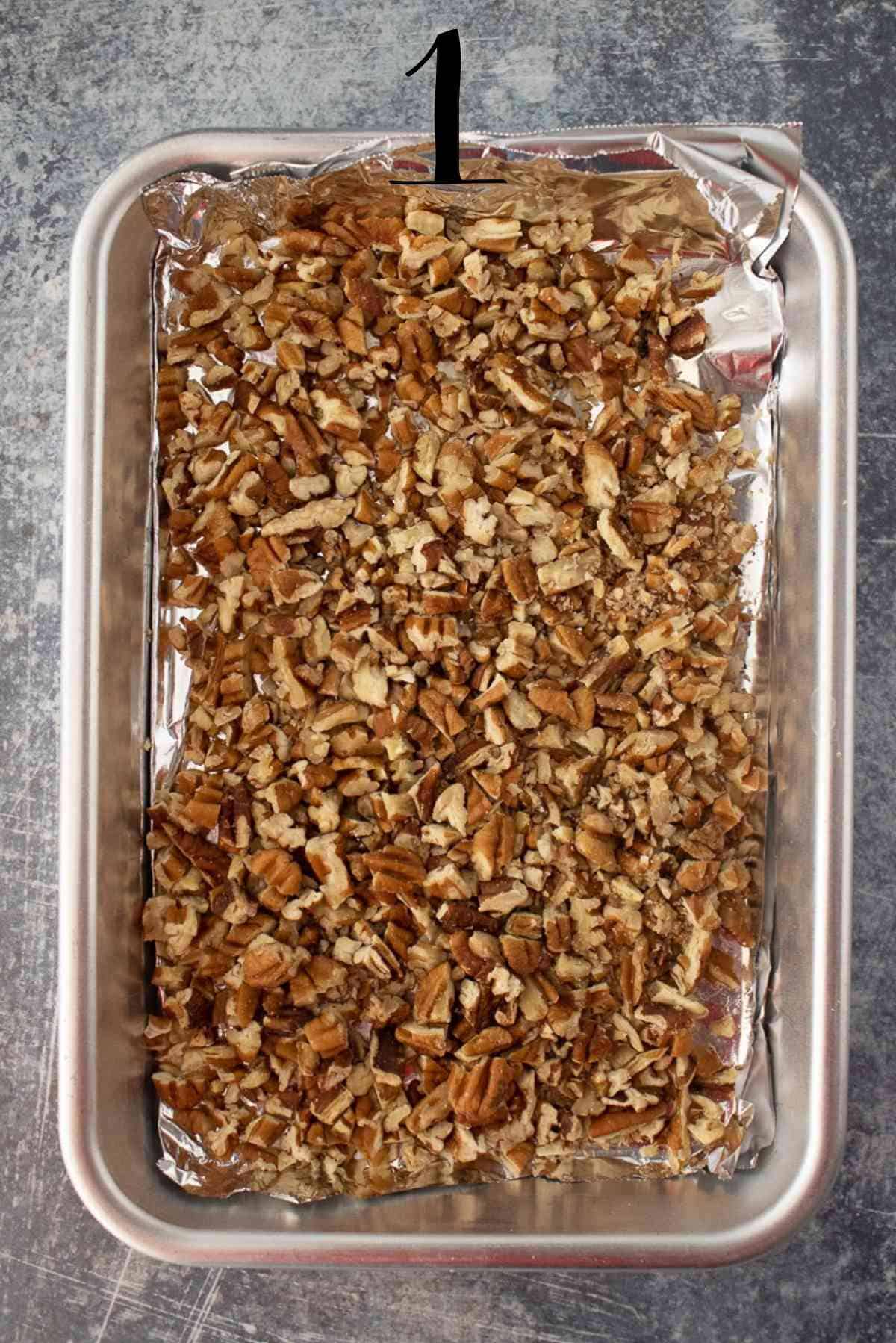 Toasted pecans on a baking sheet.