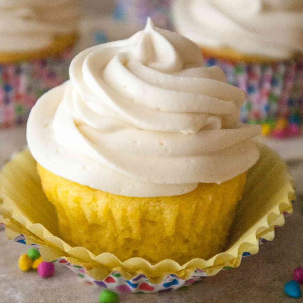 A Lemon cupcake frosted with whipped cream cheese frosting