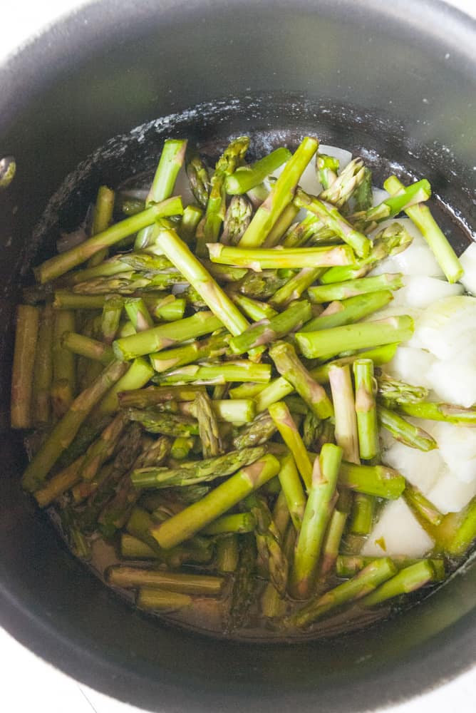 Asparagus pieces and onions lightly sauteing.