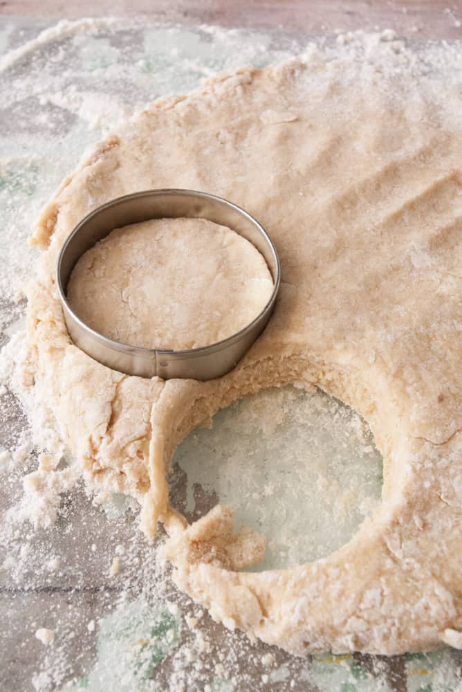Maple and brown sugar scone dough patted out and cut into circles.