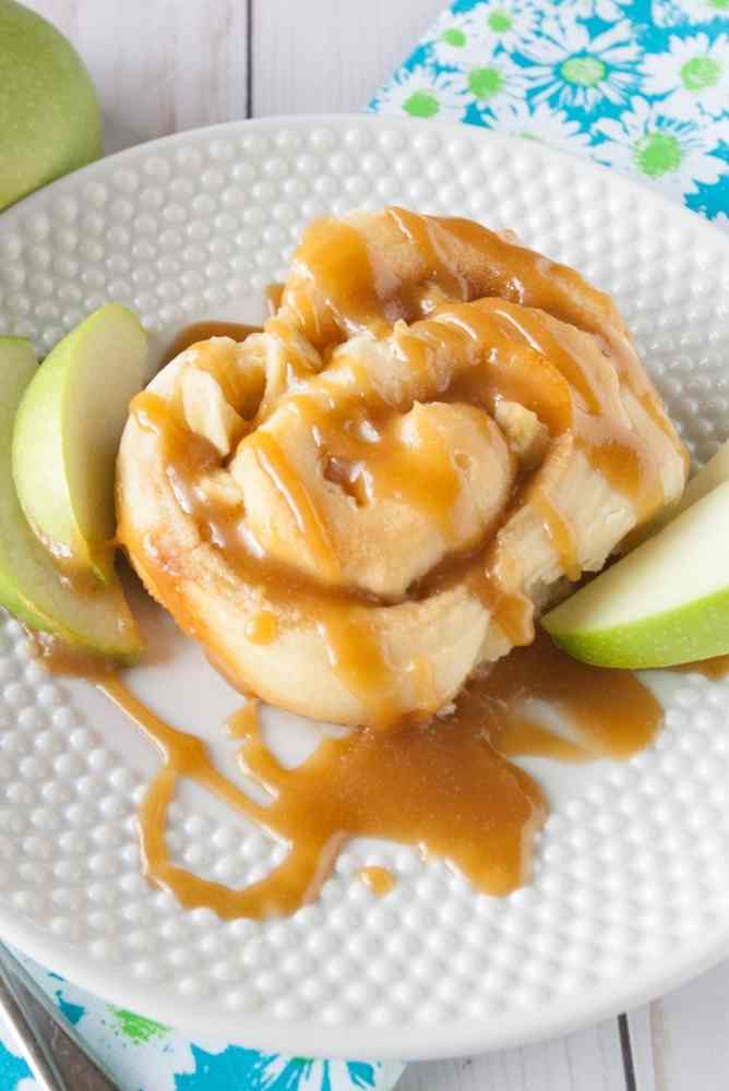 A caramel apple sweet roll on a plate.