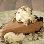 Slice of grasshopper pie garnished with whipped cream.