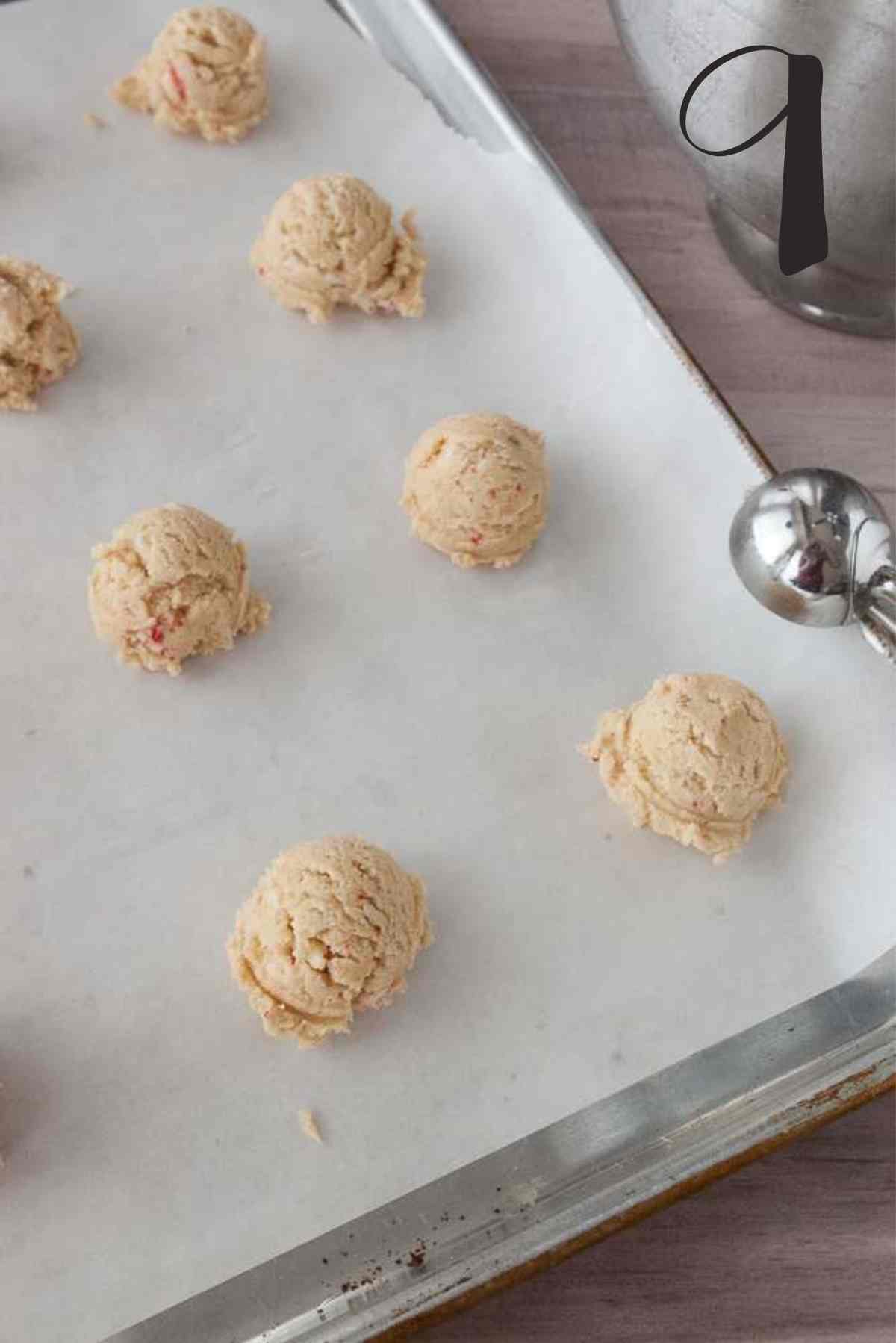 Cookie dough scooped onto baking sheet with parchment paper.