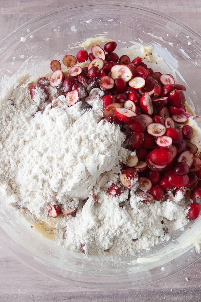 Cranberries and last bit of flour being added to the batter.