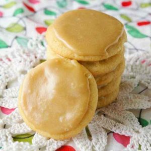 Stack of caramel butter cookies on Christmas fabric.