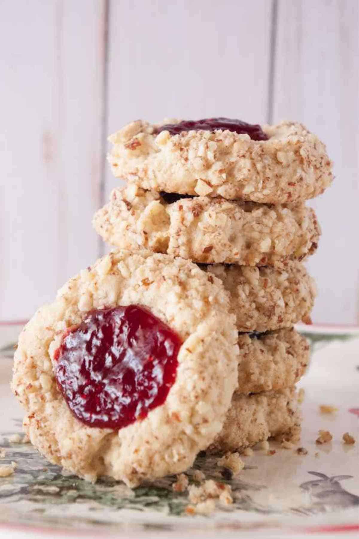 A neat stack of jam filled thumbprint cookies.