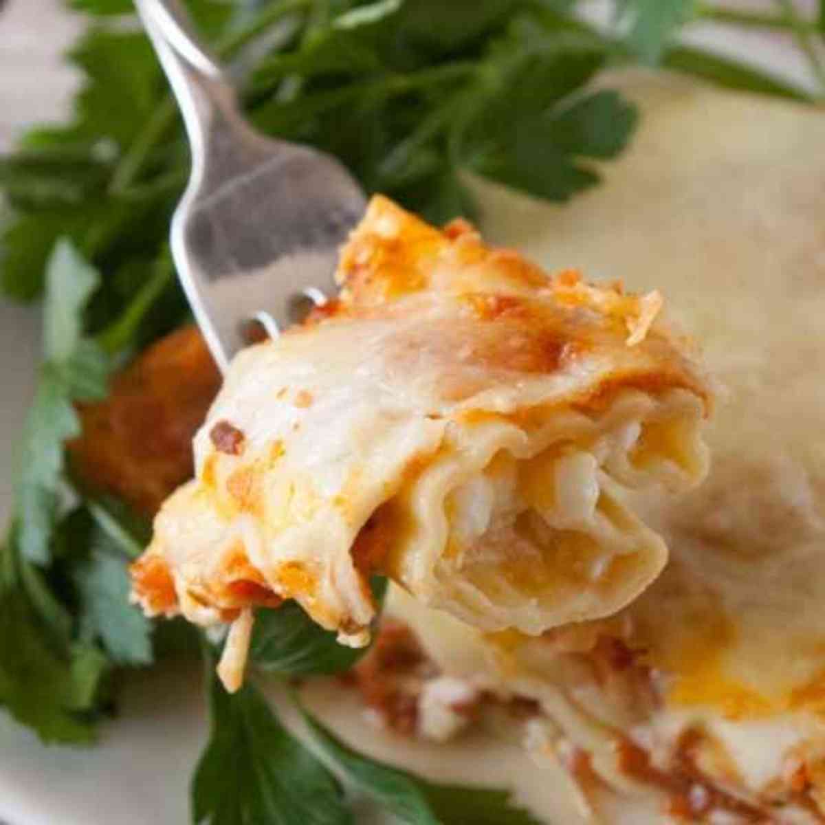 Big bite of cheese manicotti on the end of a fork!