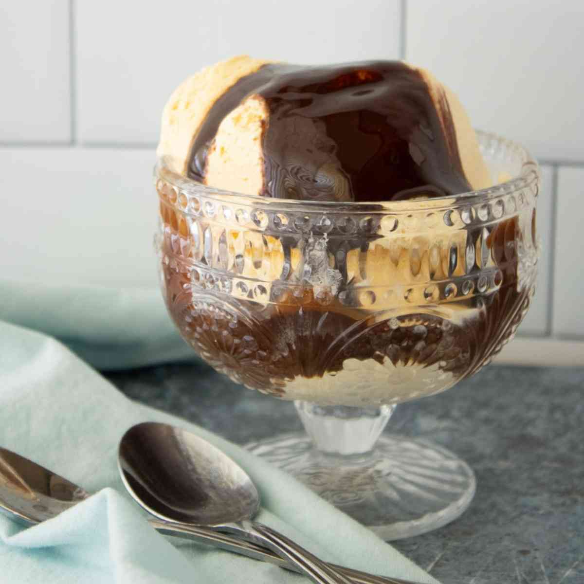 Ice Cream in a dish topped with the best chocolate syrup.