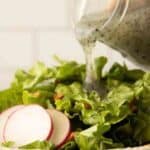 Poppy seed dressing drizzled over green salad.