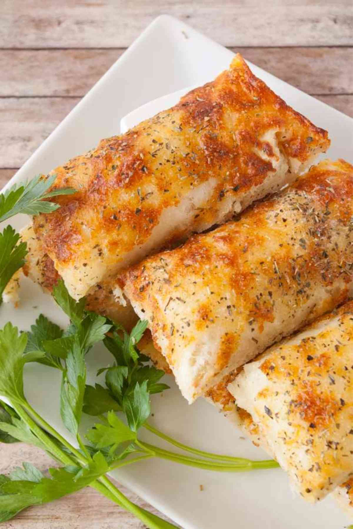 A plate of hot sticks of Copycat Italian Cheese Bread