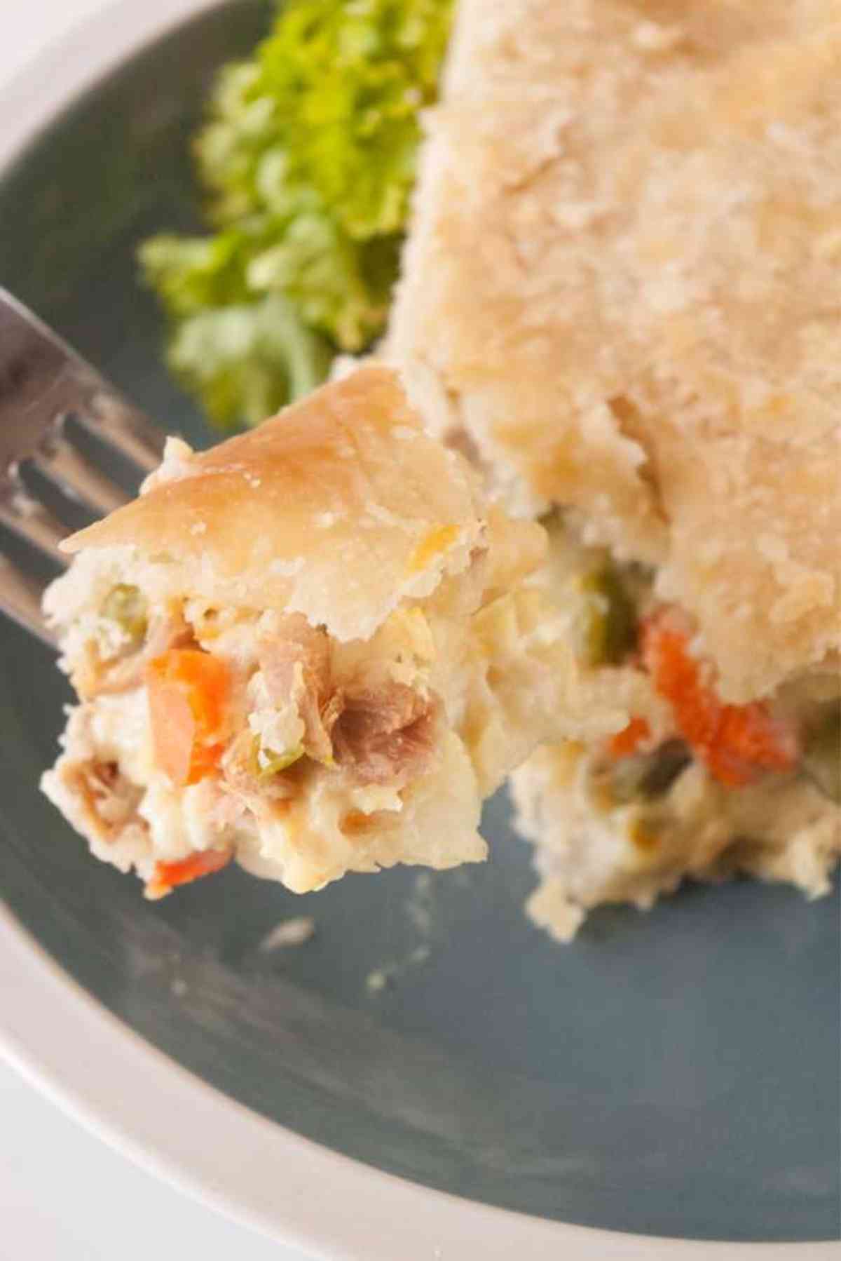 Fork lifting a bite of this turkey pot pie full of leftover thanksgiving turkey.