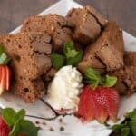 Plate of chocolate angel food cake wedges with strawberries.