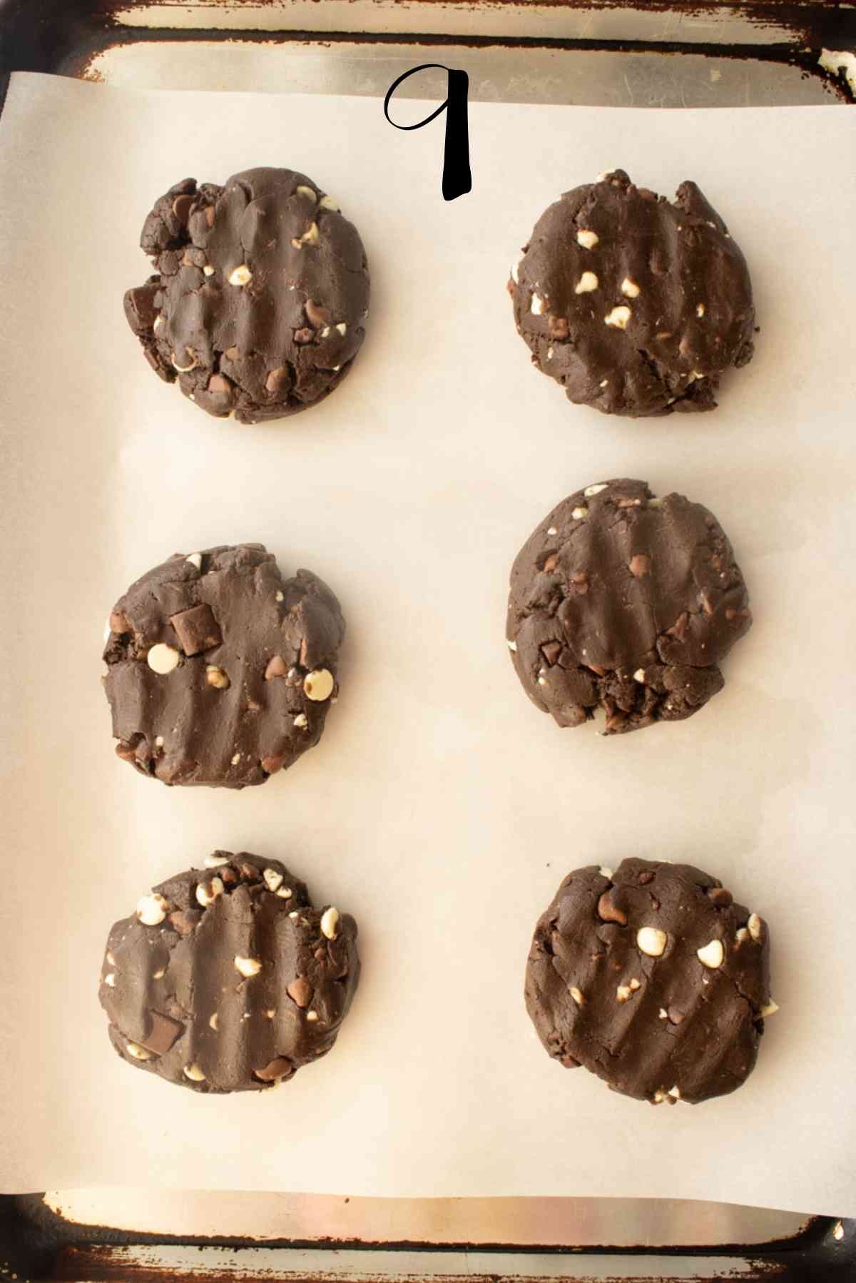 Check out the different kinds of chocolate chips in the unbaked cookies on a prepared baking sheet!