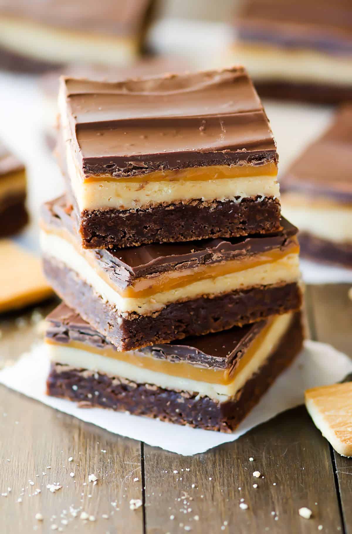 A stack of Twix Brownies on a paper napkin.