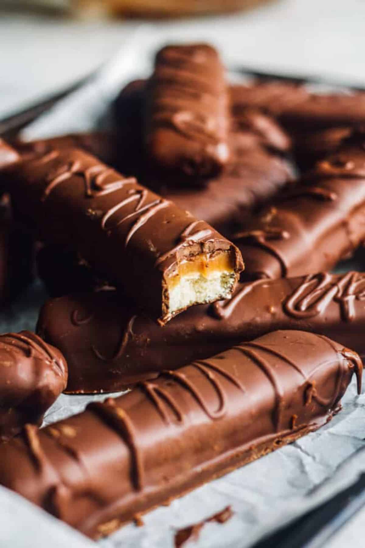 Homemade Twix Bars on a black tray.