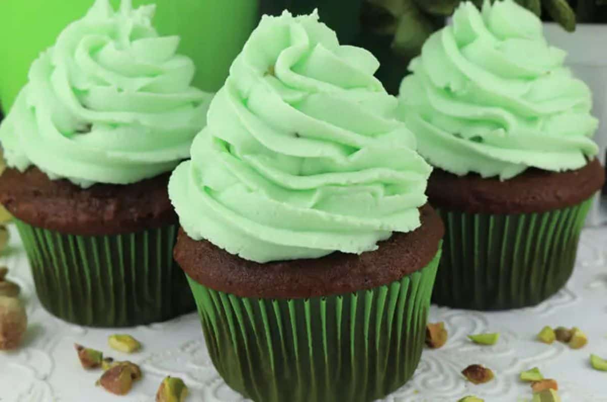 Three cupcakes with Pistachio Whipped Cream Frosting.