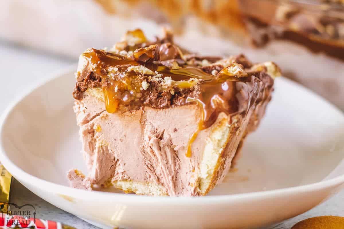 A piece of No Bake Twix Cake on a white plate.