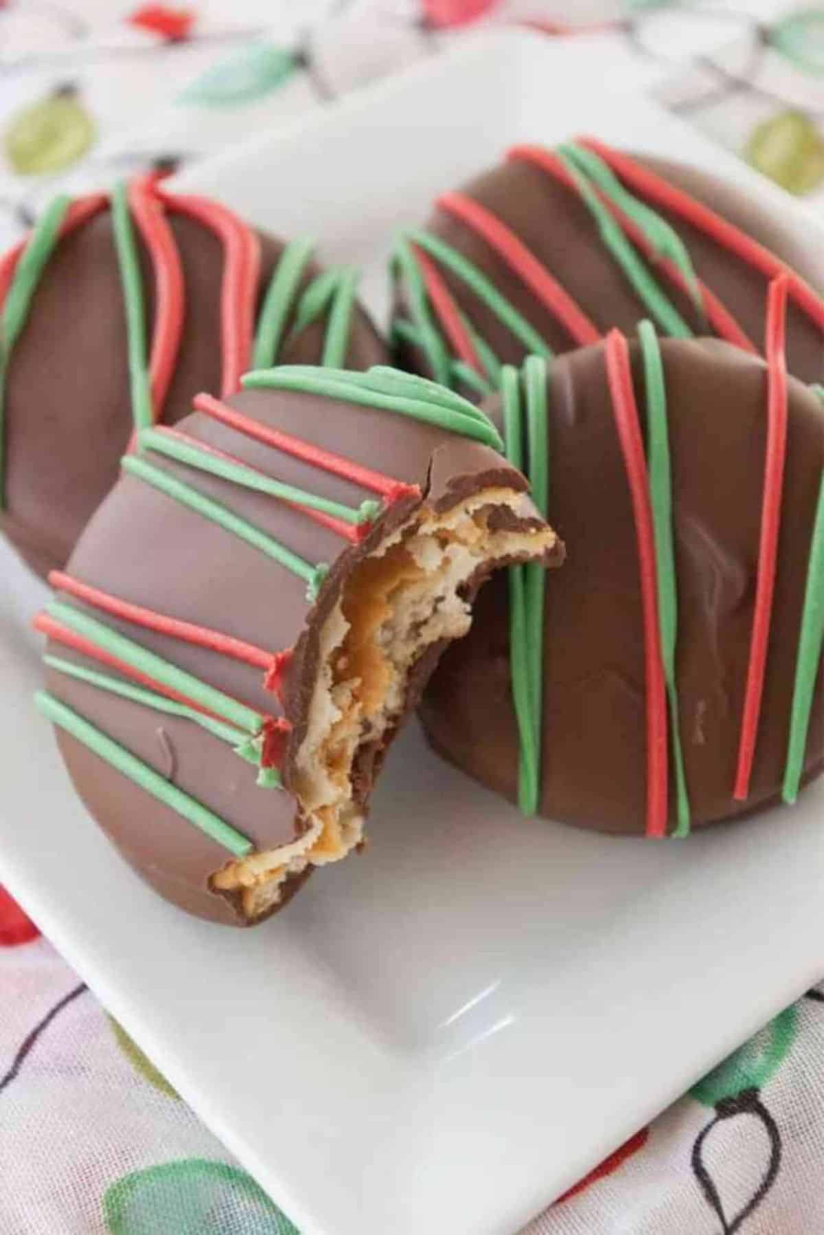 Chocolate Dipped Peanut Butter Ritz cookies on a white plate.