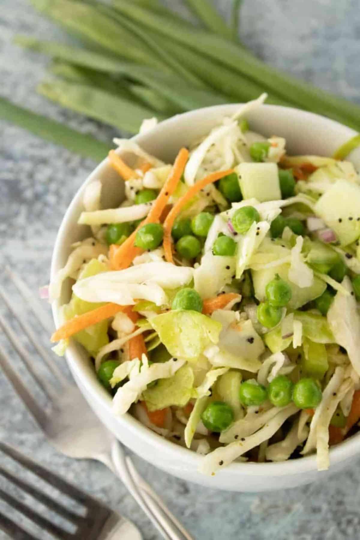 Sweet Poppy Seed Coleslaw in a white bowl.