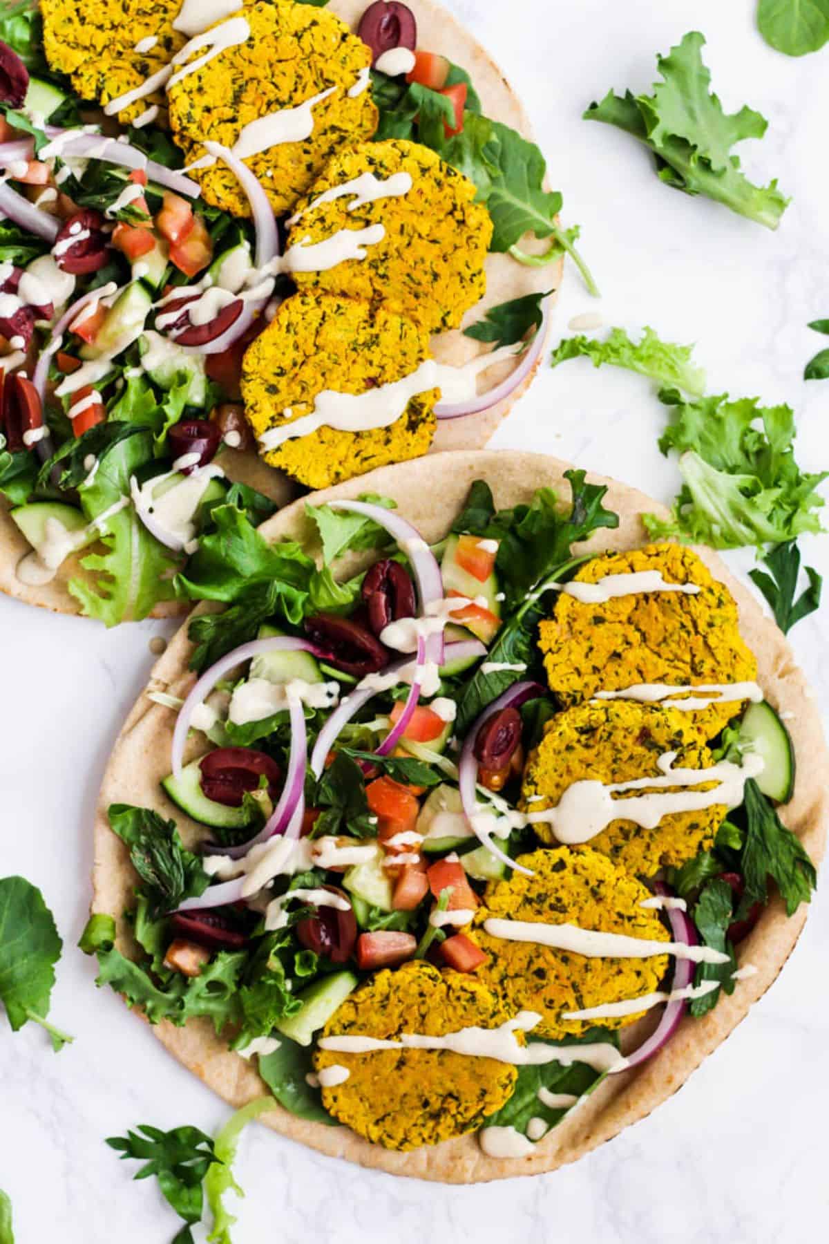 Turmeric Falafel with veggies and dip on two tortillas.