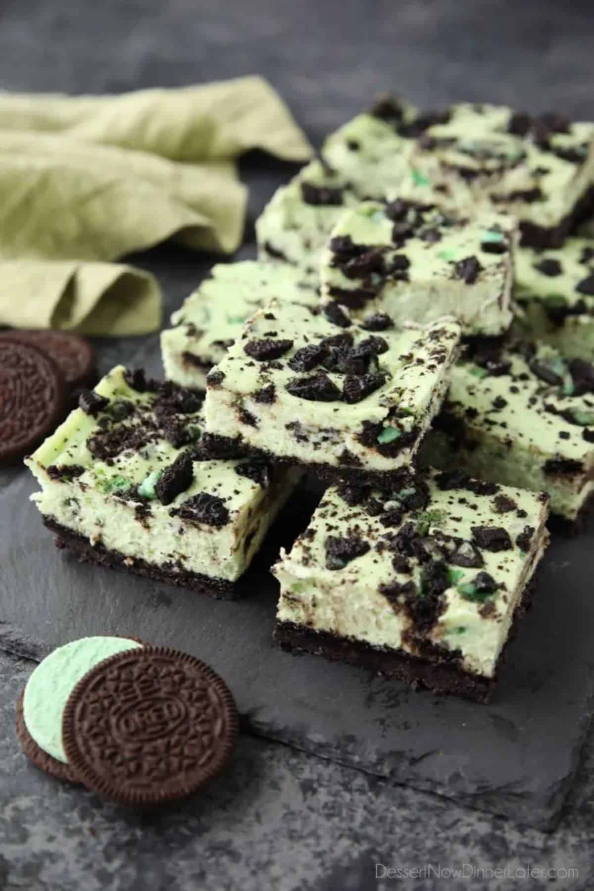 Mint Oreo Cheesecake Bars on a black tray.