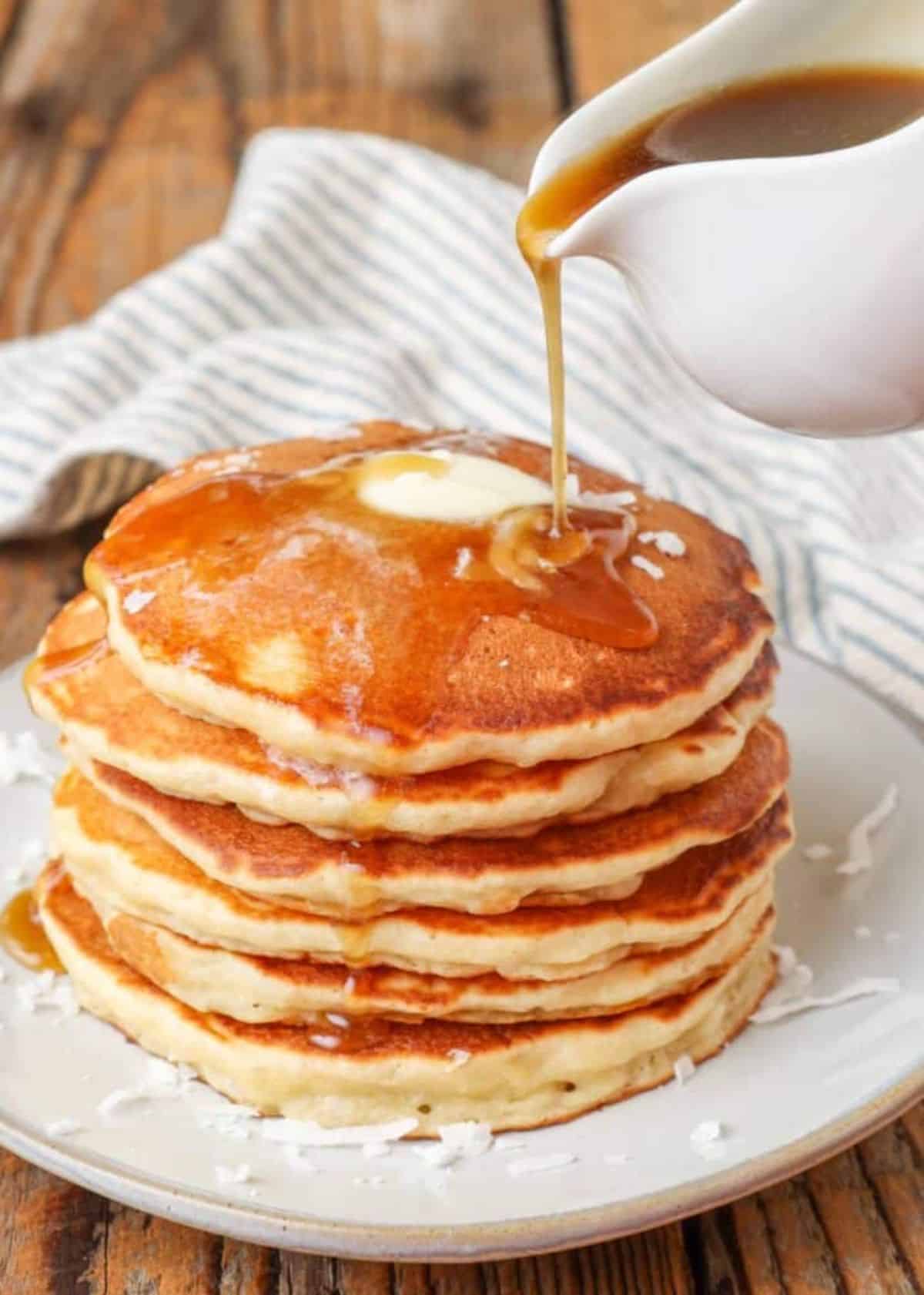 Brown Sugar Butter Syrup poured on a pile of pancakes.