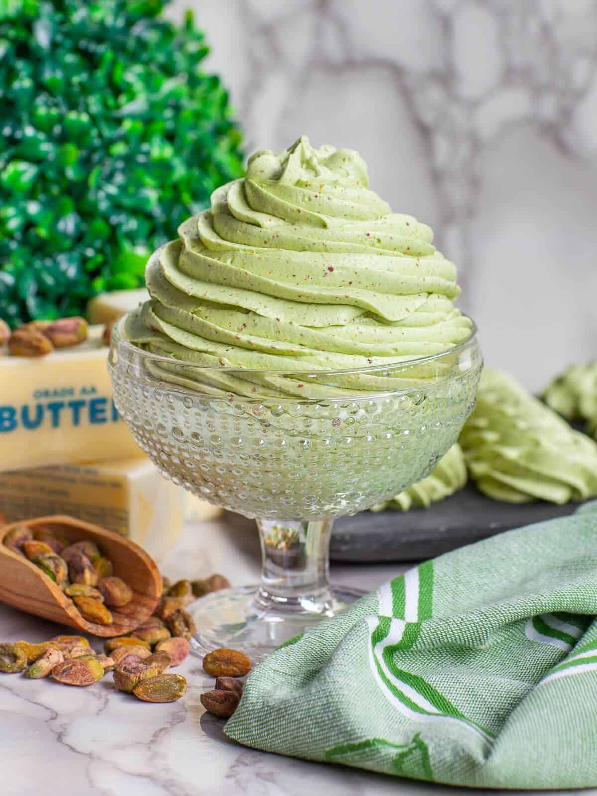 Pistachio Buttercream Frosting in a tall glass.
