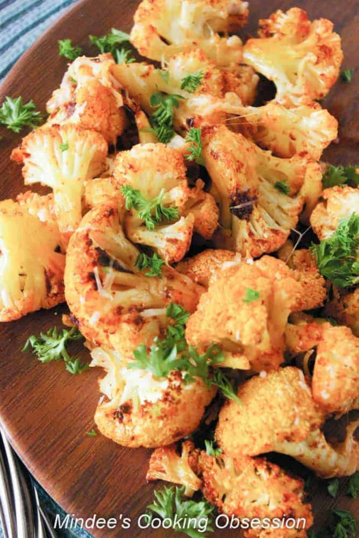 Smokey Parmesan Roasted Cauliflower on a wooden tray.