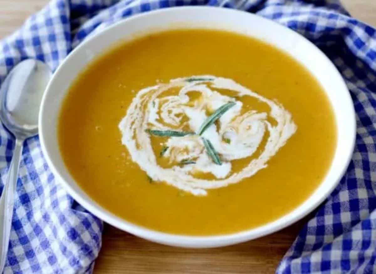 Delicious Carrot & Tarragon Soup in a white bowl.
