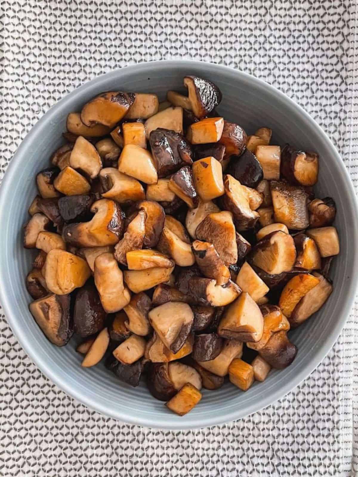 Delicious Sauteed Mushrooms With Ponzu Butter in a gray bowl.