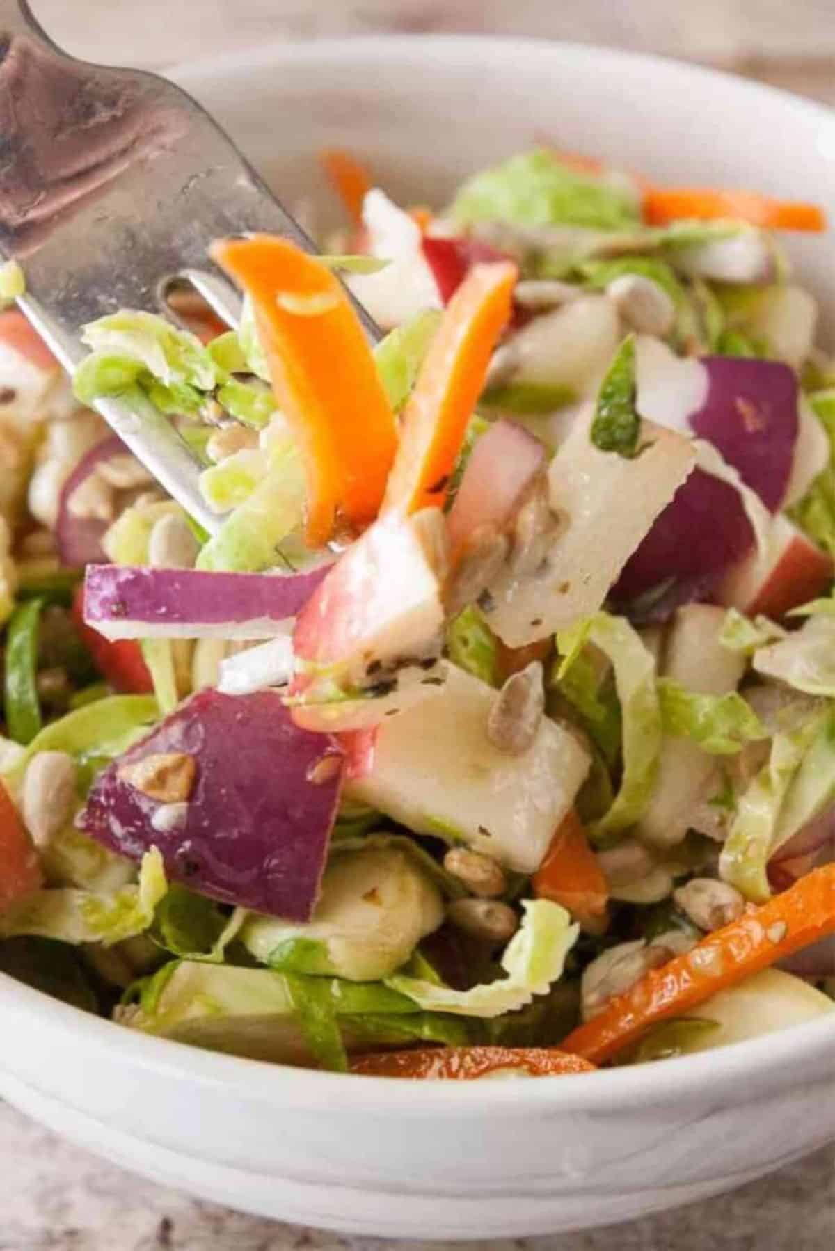 Healthy Brussels Sprouts Slaw in a white bowl.