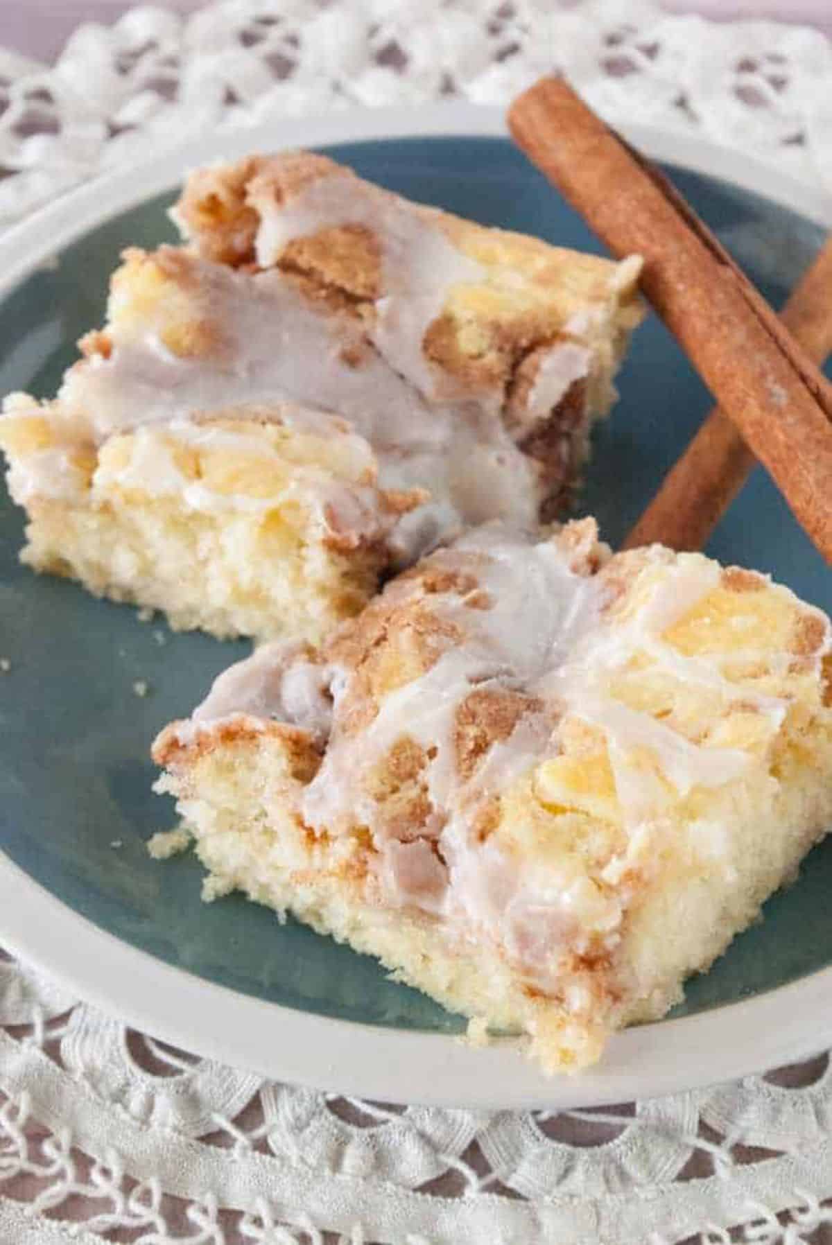 Two pieces of Snickerdoodle Coffee Cake with cinnamon rolls on a plate.