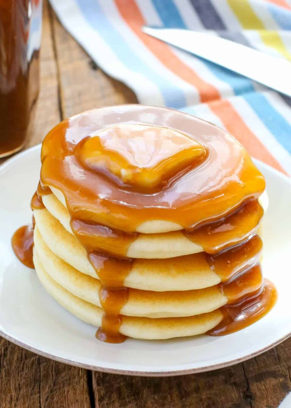 Homemade Buttermilk Syrup on a pile of pancakes.