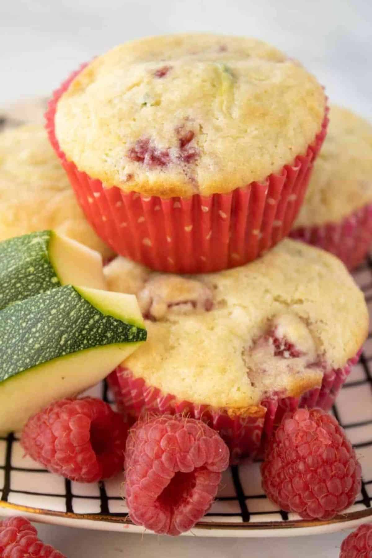 A few delicious Lemon Raspberry Zucchini Muffins on a plate.