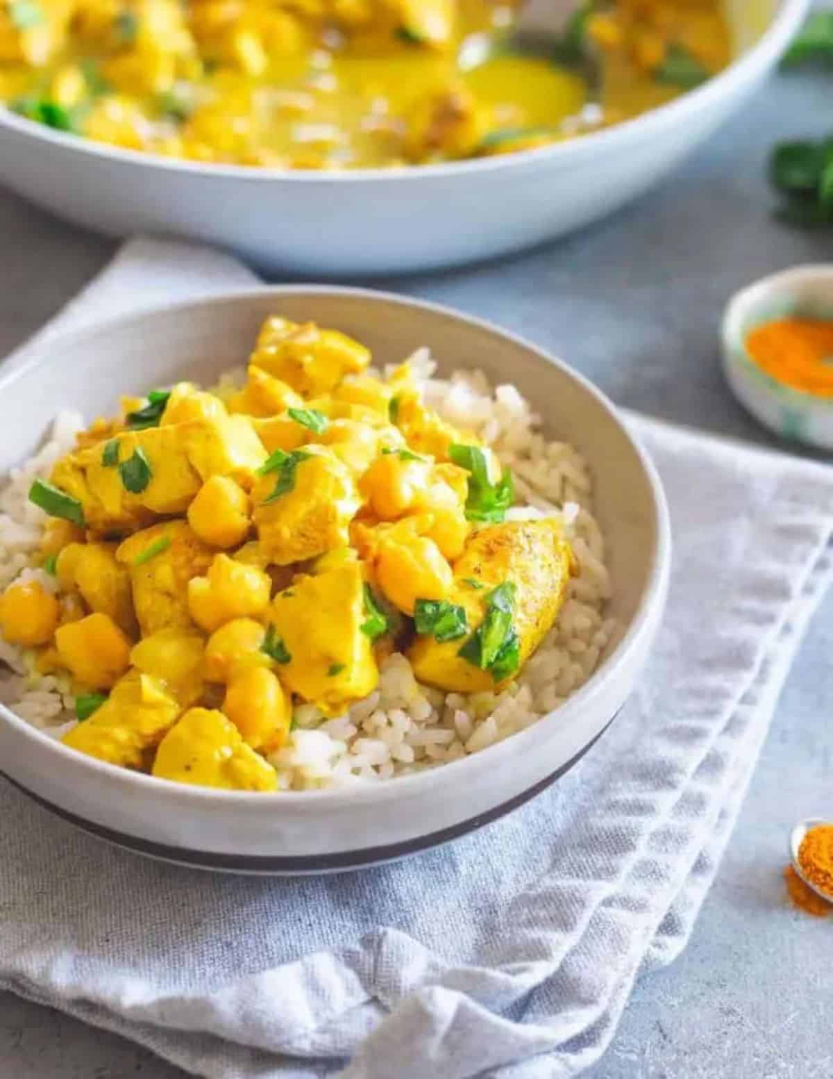 Skillet Chicken With Turmeric and Chickpeas in a white bowl.