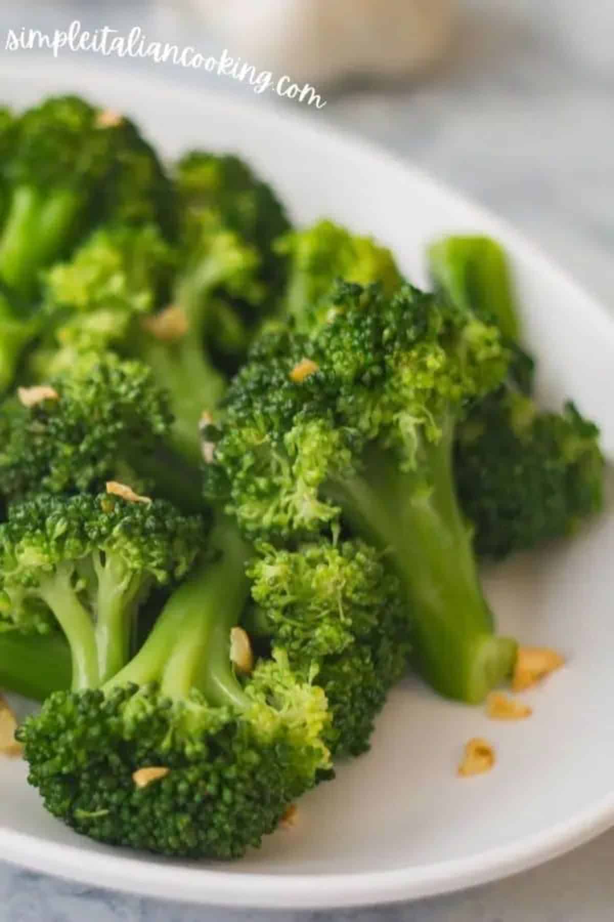 Healthy  Italian Broccoli, Olive Oil, and Garlic on a white plate.