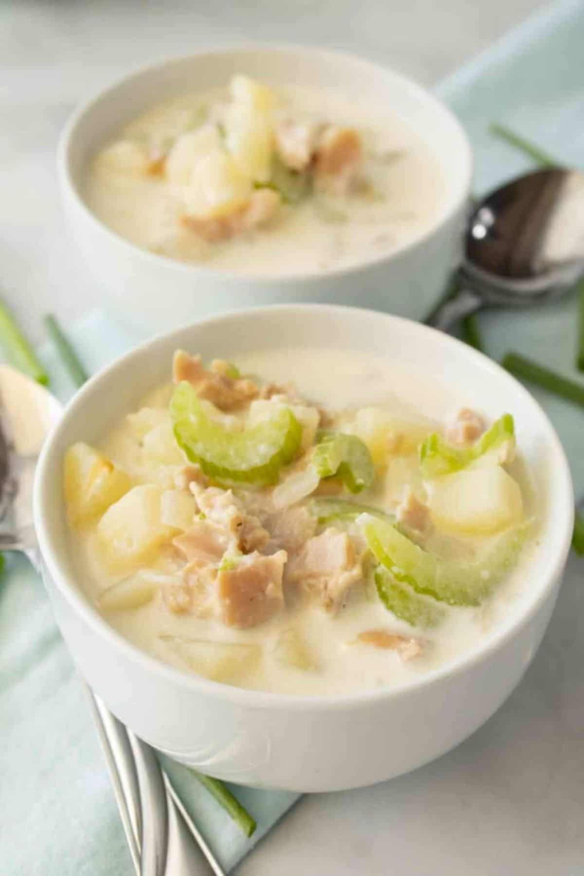 Delicious The Best Clam Chowder in two white bowls.