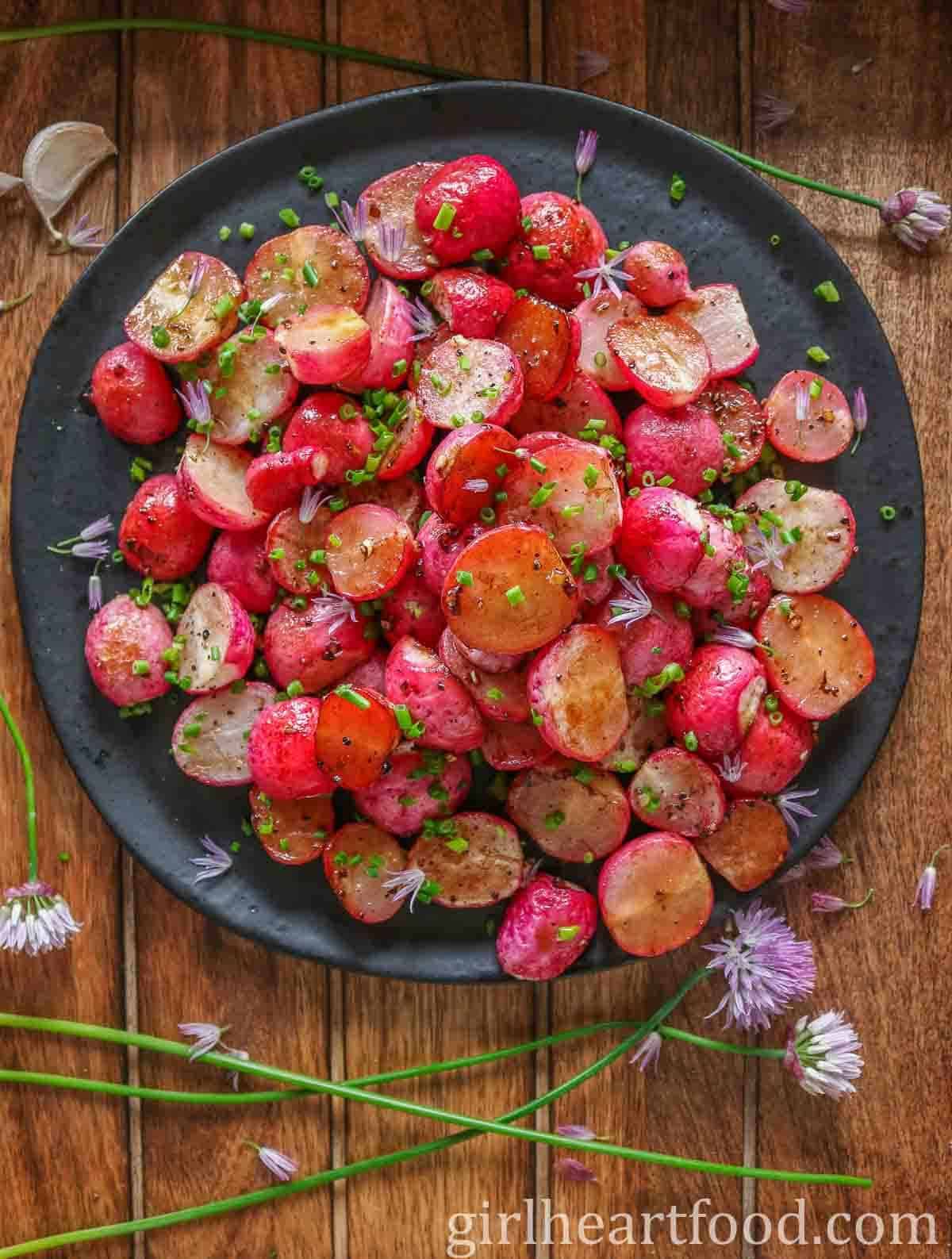 Delicious Roasted Radishes on a black plate.