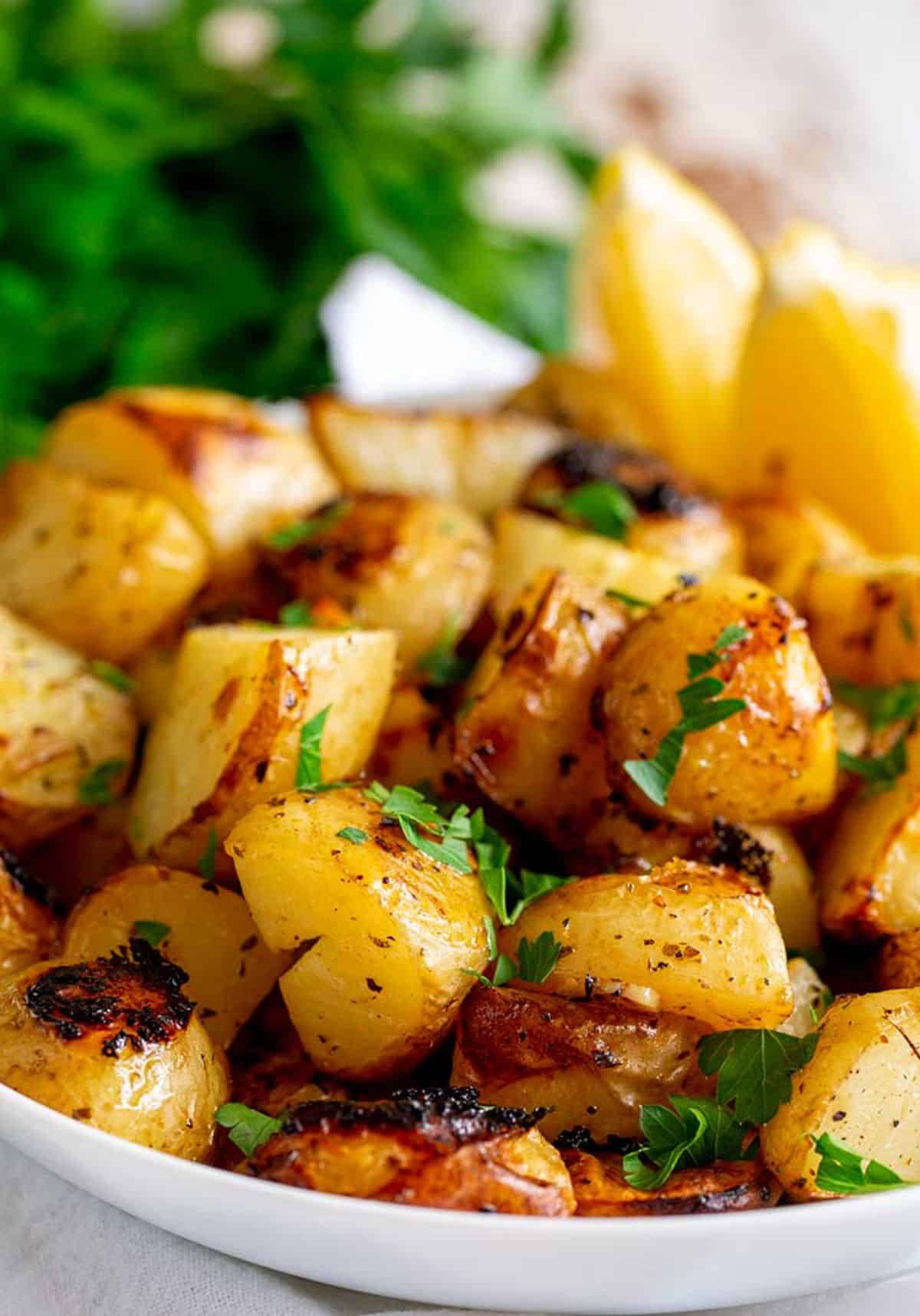 Slow-Roasted Greek Potatoes on a white plate.