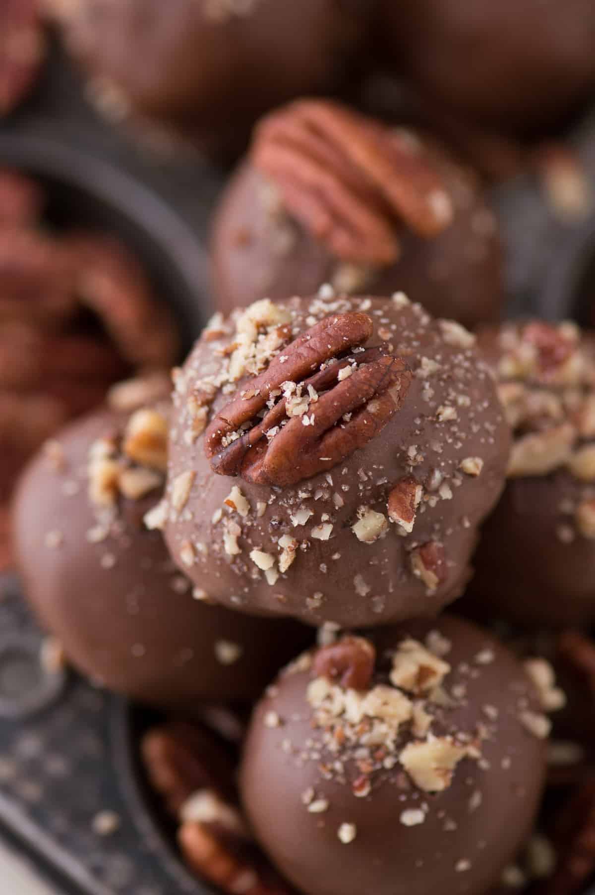 A bunch of Turtle Oreo Dessert balls  on a black tray.