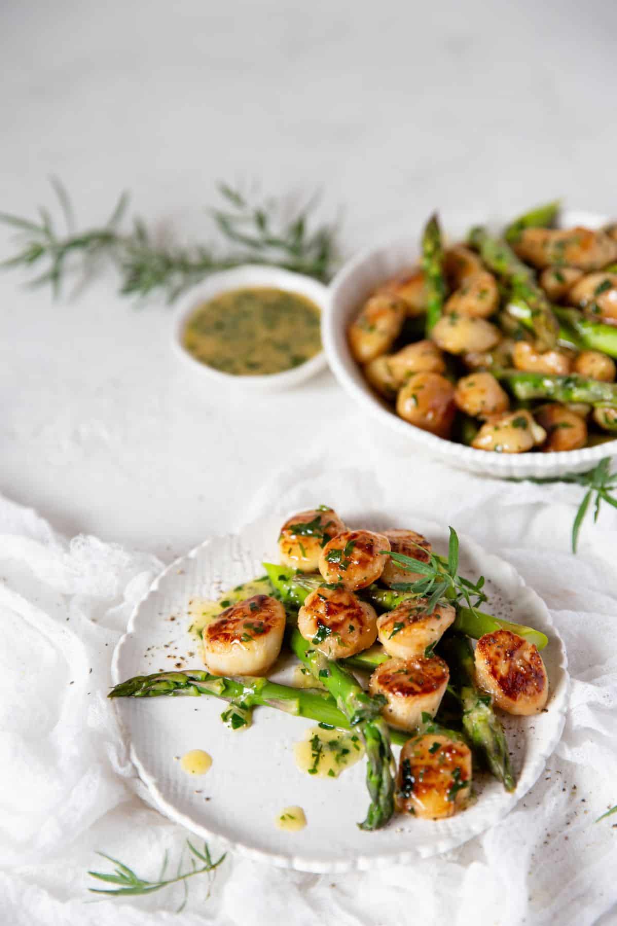 Seared Scallops With Tarragon Butter on a white plate.