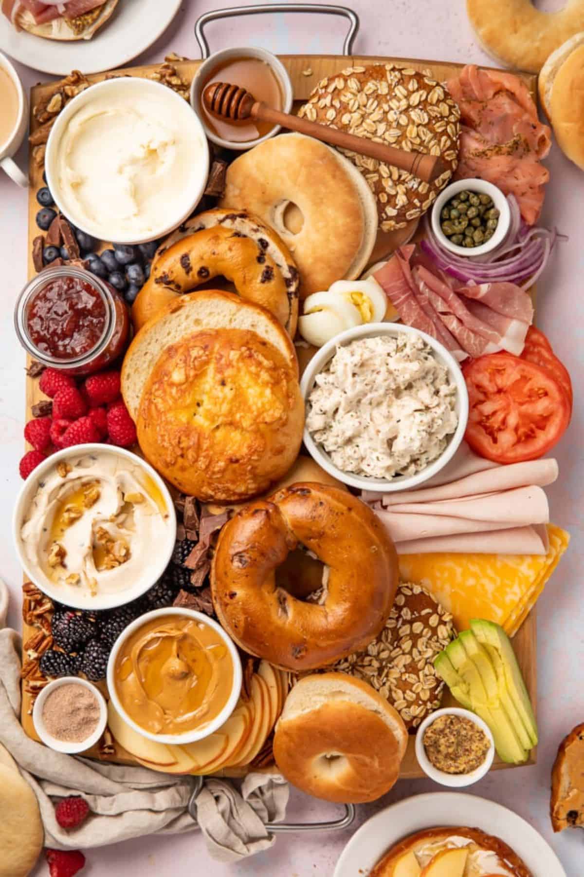 Bagel Bar with Various Toppings on a wooden tray.