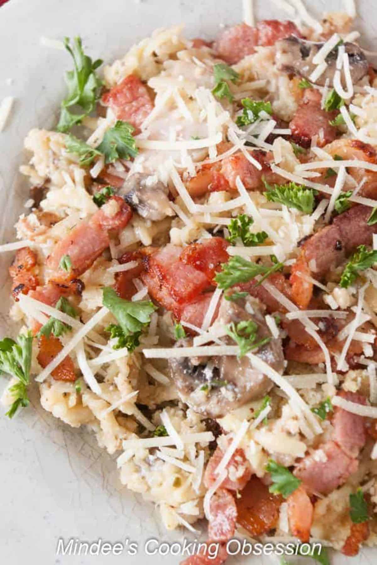 Healthy Italian Orzo Bacon Mushroom Bake on a white plate.